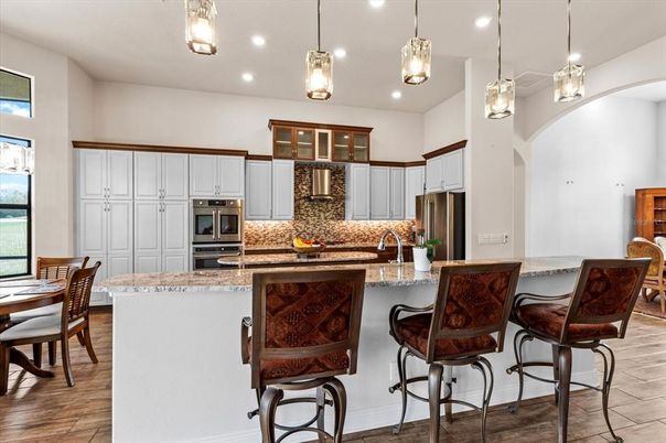 Dining room, Interior, Kitchen, Pendant Lights, Recessed Lighting, Stainless Steel Appliances, Wood Texture Flooring