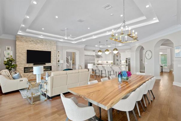 Chandelier, Dining room, Fireplace, Interior, Kitchen, Living room, Pendant Lights, Recessed Lighting, Stainless Steel Appliances, Stone Walls, Wood Texture Flooring