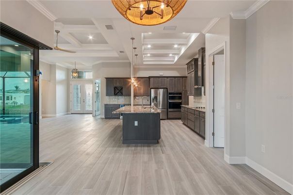 Chandelier, Interior, Kitchen, Pendant Lights, Recessed Lighting, Stainless Steel Appliances, Wood Texture Flooring