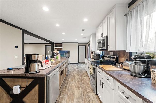 Interior, Kitchen, Recessed Lighting, Tile Countertops, Wood Texture Flooring