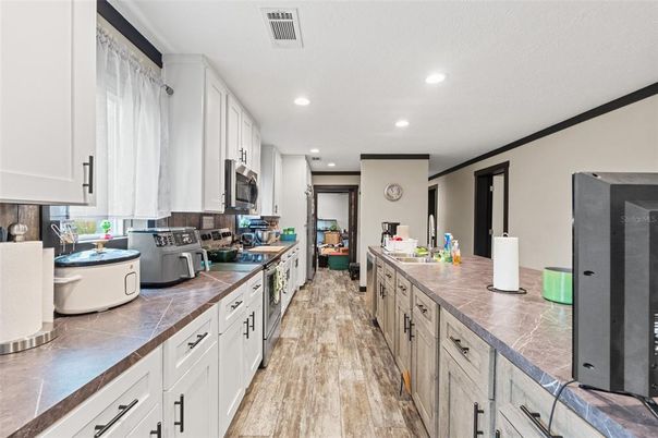 Interior, Kitchen, Recessed Lighting, Tile Countertops, Wood Texture Flooring