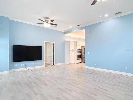 Empty room, Interior, Kitchen, Recessed Lighting, Stainless Steel Appliances, Wood Texture Flooring
