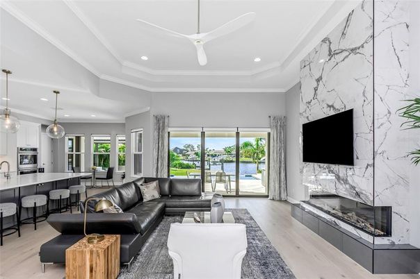 Fireplace, Interior, Kitchen, Living room, Marble Walls, Pendant Lights, Recessed Lighting, Water, Wood Texture Flooring