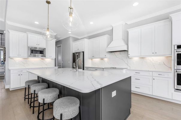 Interior, Kitchen, Marble Walls, Pendant Lights, Recessed Lighting, Stainless Steel Appliances, Wood Texture Flooring