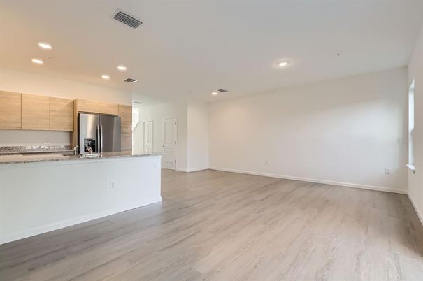 Empty room, Interior, Kitchen, Recessed Lighting, Stainless Steel Appliances, Wood Texture Flooring