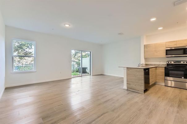 Empty room, Interior, Kitchen, Recessed Lighting, Stainless Steel Appliances, Wood Texture Flooring