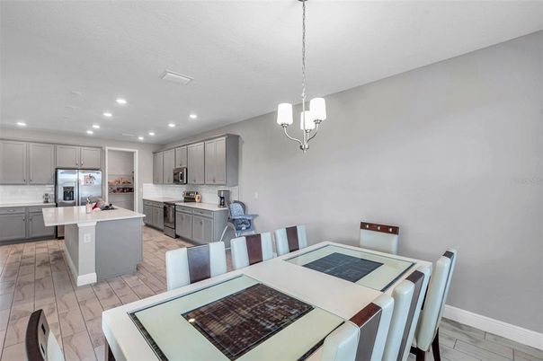 Dining room, Interior, Kitchen, Pendant Lights, Recessed Lighting, Stainless Steel Appliances, Wood Texture Flooring