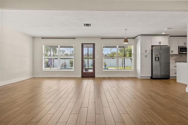 Empty room, Interior, Kitchen, Pendant Lights, Recessed Lighting, Stainless Steel Appliances, Wood Texture Flooring