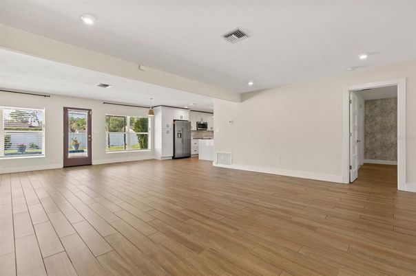 Empty room, Interior, Kitchen, Pendant Lights, Recessed Lighting, Stainless Steel Appliances, Wood Texture Flooring