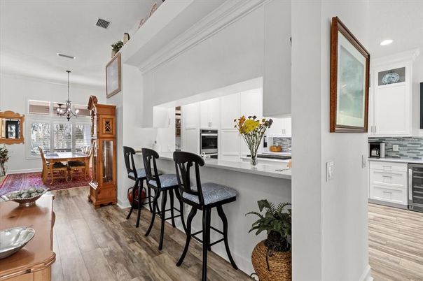 Chandelier, Dining room, Interior, Kitchen, Pendant Lights, Recessed Lighting, Stainless Steel Appliances, Wood Texture Flooring
