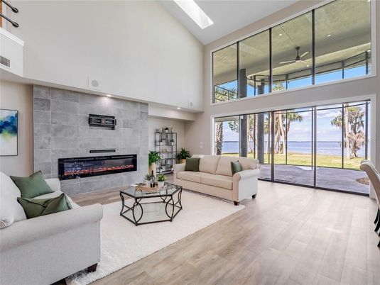 Fireplace, Interior, Living room, Recessed Lighting, Stone Walls, Water, Wood Texture Flooring