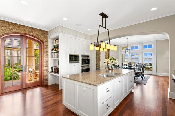 Chandelier, Dining room, Interior, Kitchen, Pendant Lights, Recessed Lighting, Stainless Steel Appliances, Wood Texture Flooring