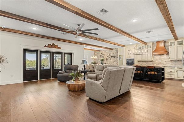 Chandelier, Dining room, Fireplace, Interior, Kitchen, Living room, Recessed Lighting, Stone Walls, Wooden Beams, Wood Texture Flooring