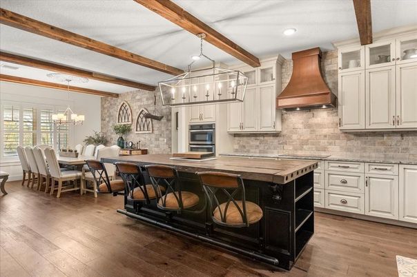 Chandelier, Dining room, Interior, Kitchen, Pendant Lights, Recessed Lighting, Stainless Steel Appliances, Stone Walls, Wooden Beams, Wood Texture Flooring