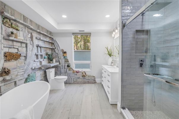 Bathroom, Dual Sink Vanities, Free Standing Baths, Glass Shower, Interior, Recessed Lighting, Stone Walls, Wood Texture Flooring