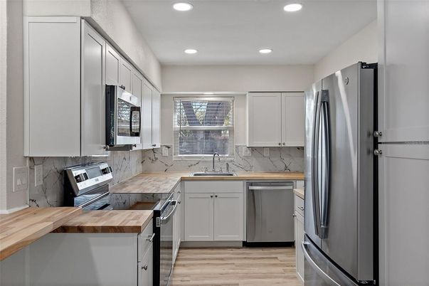 Interior, Kitchen, Marble Walls, Recessed Lighting, Stainless Steel Appliances, Wood Texture Flooring