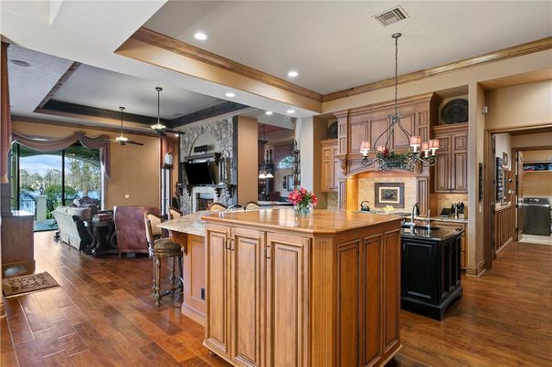Chandelier, Interior, Kitchen, Living room, Pendant Lights, Recessed Lighting, Stainless Steel Appliances, Wood Texture Flooring