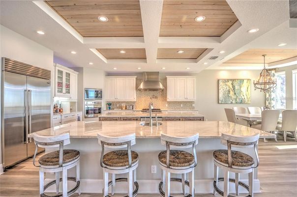 Chandelier, Dining room, Interior, Kitchen, Recessed Lighting, Stainless Steel Appliances, Wooden Ceilings, Wood Texture Flooring