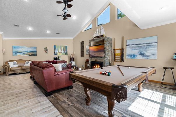 Billiard Table, Fireplace, Game Room, Interior, Living room, Recessed Lighting, Wood Texture Flooring