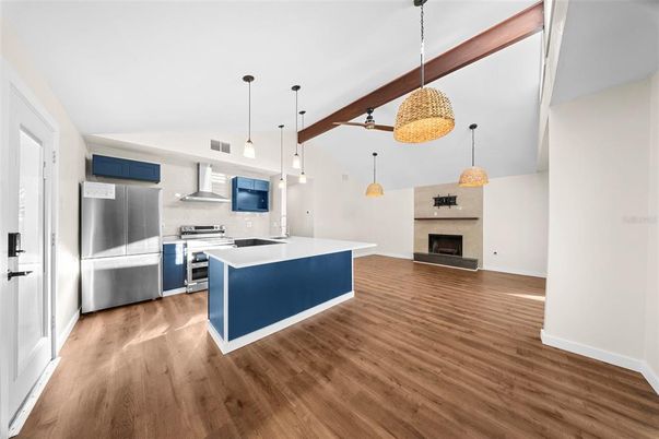 Fireplace, Interior, Kitchen, Pendant Lights, Stainless Steel Appliances, Wood Texture Flooring