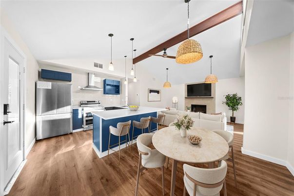 Dining room, Fireplace, Interior, Kitchen, Living room, Pendant Lights, Stainless Steel Appliances, Wood Texture Flooring