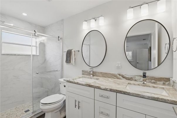 Bathroom, Dual Sink Vanities, Glass Shower, Interior, Marble Walls, Recessed Lighting