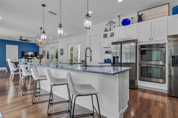 Chandelier, Dining room, Interior, Kitchen, Pendant Lights, Recessed Lighting, Stainless Steel Appliances, Wood Texture Flooring