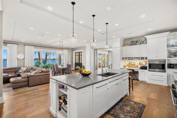 Dining room, Interior, Kitchen, Living room, Pendant Lights, Recessed Lighting, Stainless Steel Appliances, Water, Wood Texture Flooring