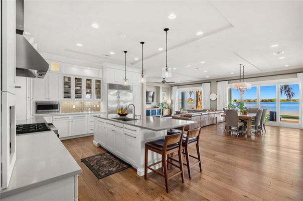 Dining room, Interior, Kitchen, Living room, Pendant Lights, Recessed Lighting, Stainless Steel Appliances, Water, Wood Texture Flooring