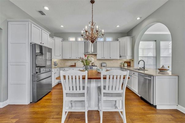 Chandelier, Interior, Kitchen, Pendant Lights, Recessed Lighting, Stainless Steel Appliances, Wood Texture Flooring