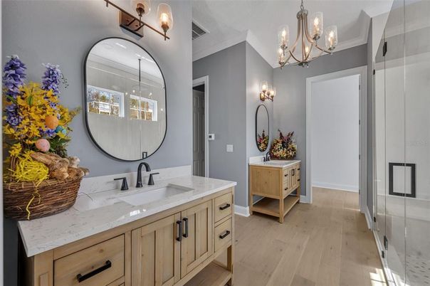 Bathroom, Chandelier, Dual Sink Vanities, Interior, Wood Texture Flooring
