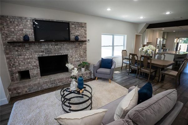 Dining room, Fireplace, Interior, Kitchen, Living room, Recessed Lighting, Stainless Steel Appliances, Stone Walls, Wood Texture Flooring