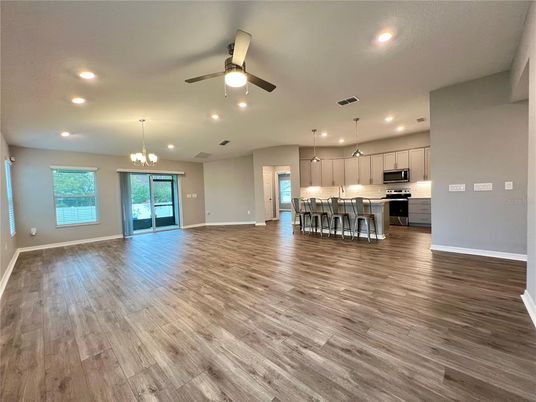 Chandelier, Empty room, Interior, Kitchen, Pendant Lights, Recessed Lighting, Stainless Steel Appliances, Wood Texture Flooring