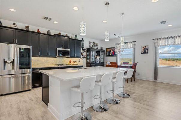 Chandelier, Dining room, Interior, Kitchen, Pendant Lights, Recessed Lighting, Stainless Steel Appliances, Wood Texture Flooring