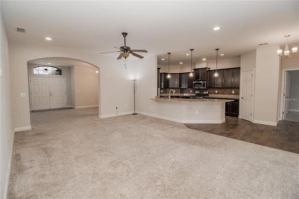 Chandelier, Empty room, Interior, Kitchen, Pendant Lights, Recessed Lighting, Stainless Steel Appliances, Wood Texture Flooring