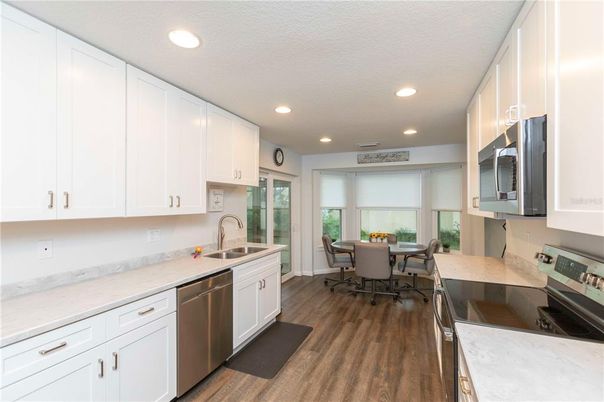 Dining room, Interior, Kitchen, Recessed Lighting, Stainless Steel Appliances, Wood Texture Flooring