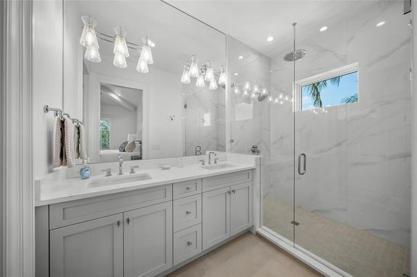 Bathroom, Dual Sink Vanities, Glass Shower, Interior, Marble Walls, Recessed Lighting