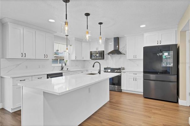 Interior, Kitchen, Marble Walls, Pendant Lights, Recessed Lighting, Stainless Steel Appliances, Wood Texture Flooring