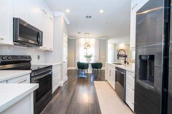 Dining room, Interior, Kitchen, Pendant Lights, Recessed Lighting, Stainless Steel Appliances, Wood Texture Flooring