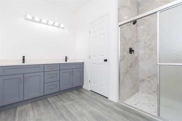Bathroom, Dual Sink Vanities, Glass Shower, Interior, Marble Walls, Wood Texture Flooring