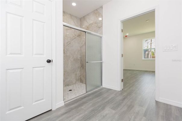Bathroom, Glass Shower, Interior, Marble Walls, Recessed Lighting, Wood Texture Flooring