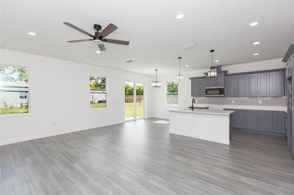Empty room, Interior, Kitchen, Pendant Lights, Recessed Lighting, Stainless Steel Appliances, Wood Texture Flooring
