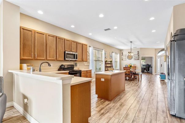 Dining room, Interior, Kitchen, Pendant Lights, Recessed Lighting, Stainless Steel Appliances, Wood Texture Flooring