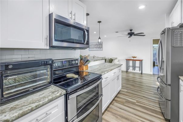 Dining room, Interior, Kitchen, Pendant Lights, Recessed Lighting, Stainless Steel Appliances, Wood Texture Flooring