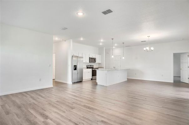 Empty room, Interior, Kitchen, Pendant Lights, Recessed Lighting, Stainless Steel Appliances, Wood Texture Flooring