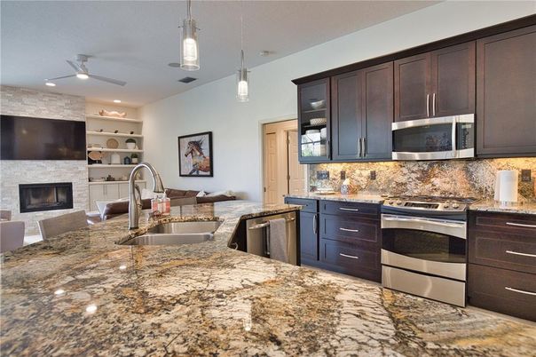 Fireplace, Interior, Kitchen, Pendant Lights, Recessed Lighting, Stainless Steel Appliances, Stone Walls
