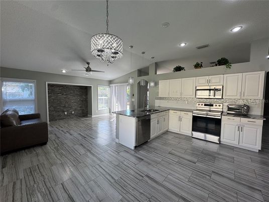 Interior, Kitchen, Pendant Lights, Recessed Lighting, Stainless Steel Appliances, Stone Walls, Wood Texture Flooring