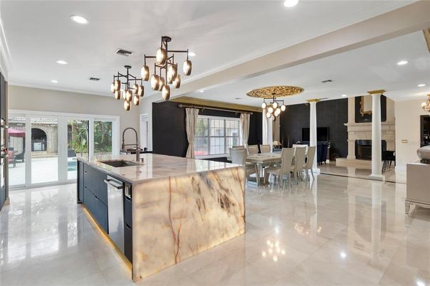 Chandelier, Dining room, Fireplace, Interior, Kitchen, Living room, Pendant Lights, Recessed Lighting, Stainless Steel Appliances