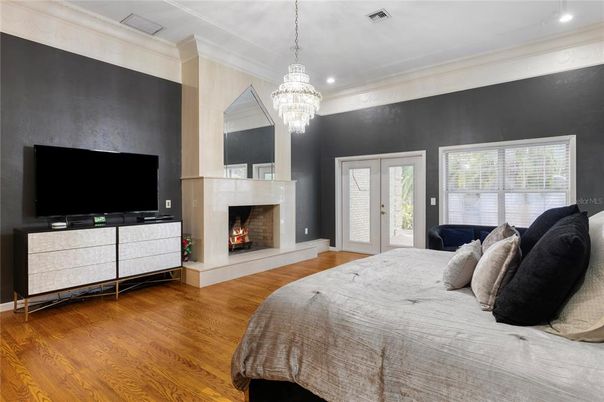 Bedroom, Chandelier, Fireplace, Interior, Recessed Lighting, Wood Texture Flooring
