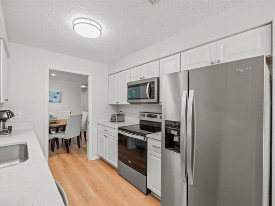 Dining room, Interior, Kitchen, Recessed Lighting, Stainless Steel Appliances, Wood Texture Flooring